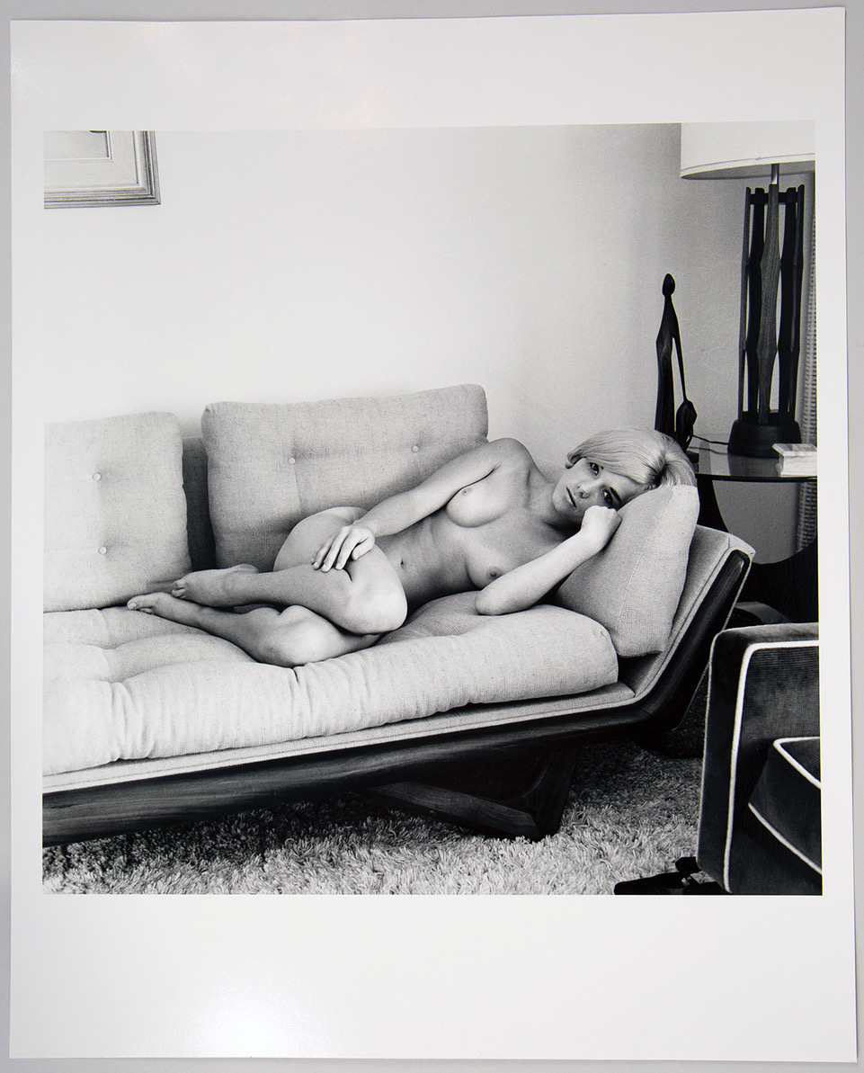 Model Marci Lane nude on a couch by Bunny Yeager, 1960s